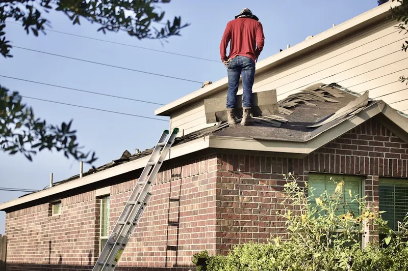 Professional roofer working on a residential roof in Oakwood Park